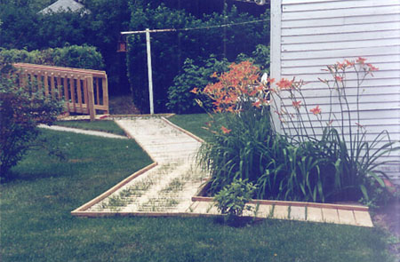 [photo of lawn with snaking boardwalk]